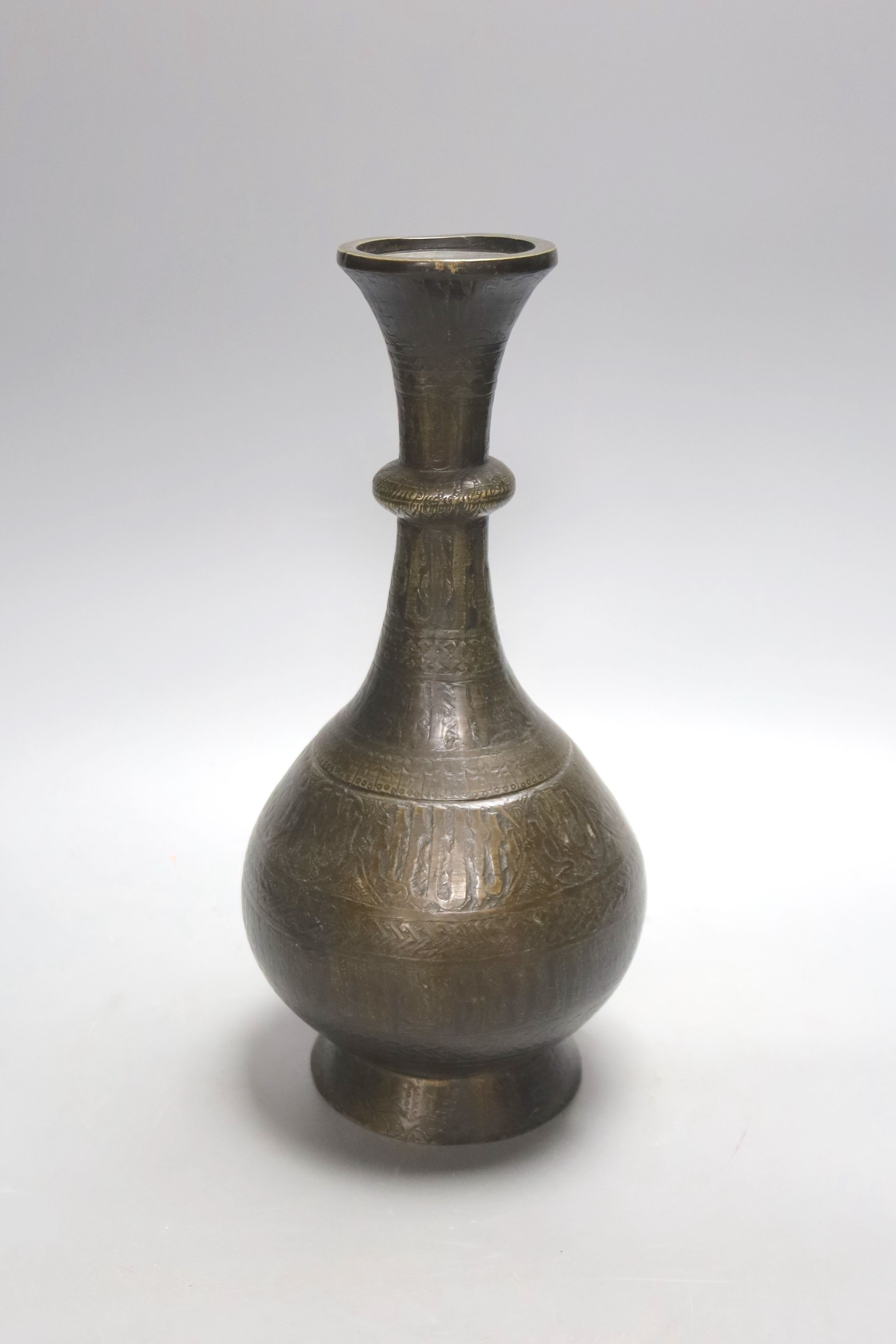 A Middle Eastern Islamic bronze vase, 28 cms high.